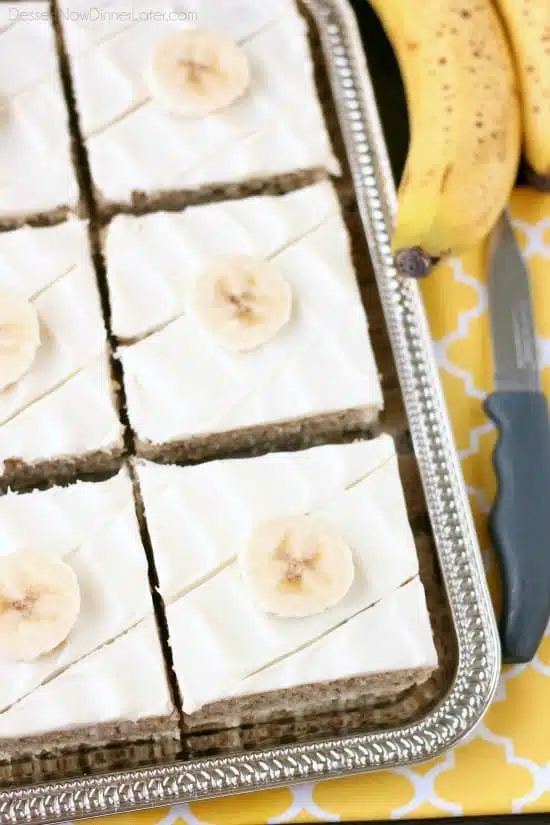 This is the BEST banana cake topped with the BEST cream cheese frosting! Perfect for picnics and potlucks, this banana sheet cake is a crowd pleaser! Everyone asks for the recipe!