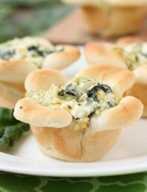 Creamy Spinach Artichoke Dip is baked in the center of bread cups that are shaped to look like blooming flowers. A fun and delicious Easter appetizer.