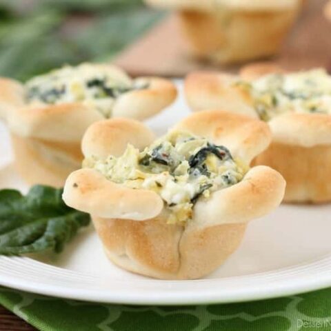 Creamy Spinach Artichoke Dip is baked in the center of bread cups that are shaped to look like blooming flowers. A fun and delicious Easter appetizer.
