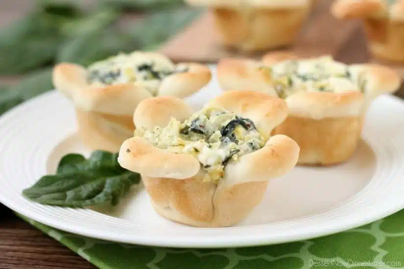 Creamy Spinach Artichoke Dip is baked in the center of bread cups that are shaped to look like blooming flowers. A fun and delicious Easter appetizer.