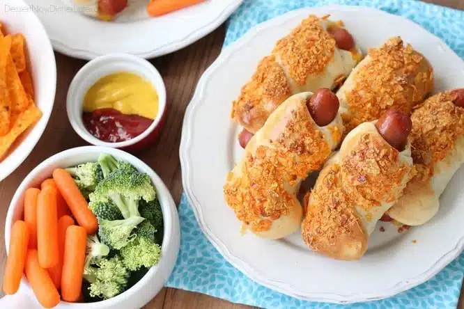 Frozen dough, nacho tortilla chips, and extra cheese transform ordinary pigs in a blanket into these extraordinary crunchy nacho dogs. 