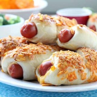 Frozen dough, nacho tortilla chips, and extra cheese transform ordinary pigs in a blanket into these extraordinary crunchy nacho dogs.