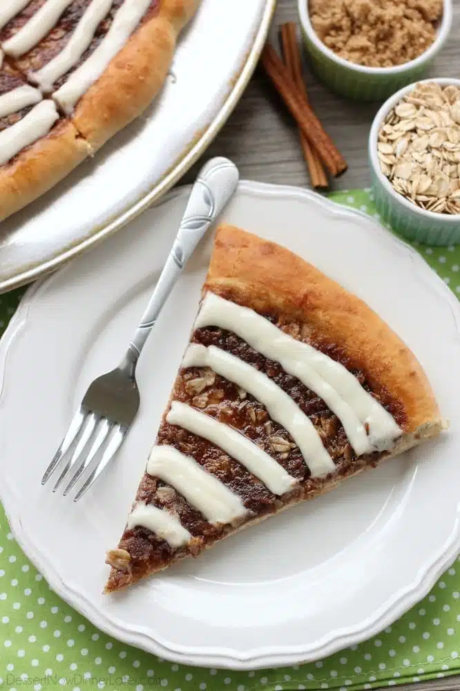 This Cinnamon Roll Dessert Pizza is an amazing copycat version of Papa Murphy's Cinnamon Wheel, with brown sugar, cinnamon, and oats, topped with a tangy cream cheese icing.