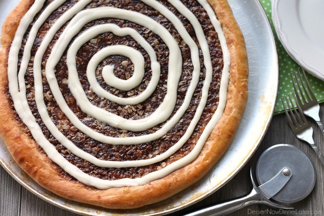 This Cinnamon Roll Dessert Pizza is an amazing copycat version of Papa Murphy's Cinnamon Wheel, with brown sugar, cinnamon, and oats, topped with a tangy cream cheese icing.