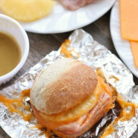 These Hot Ham and Pineapple Campfire Sandwiches are a delicious and easy tin foil recipe. Plus cleanup is a breeze! (You can even bake these in the oven too!)