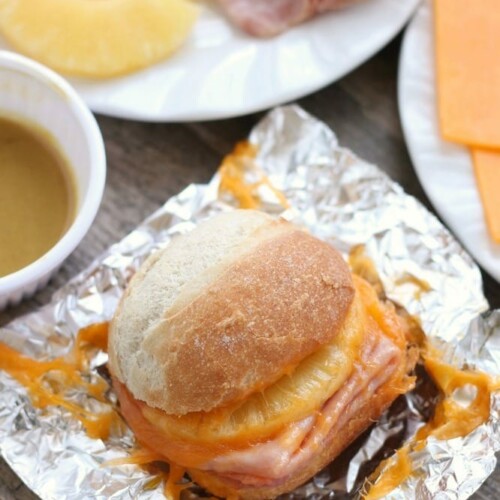 These Hot Ham and Pineapple Campfire Sandwiches are a delicious and easy tin foil recipe. Plus cleanup is a breeze! (You can even bake these in the oven too!)