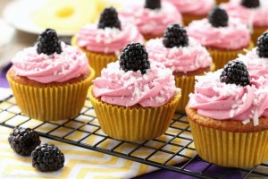 Blackberry Piña Colada Cupcakes - Moist coconut cupcakes with a sweet pineapple and rum filling topped with fresh blackberry frosting. A delicious drink inspired cupcake with a twist!