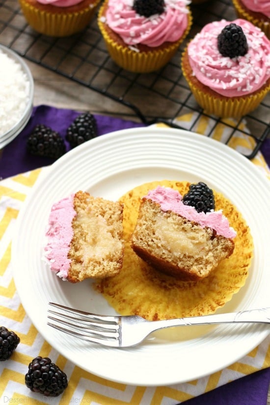 Blackberry Piña Colada Cupcakes - Moist coconut cupcakes with a sweet pineapple and rum filling topped with fresh blackberry frosting. A delicious drink inspired cupcake with a twist! (Cupcake Battles WINNER!)