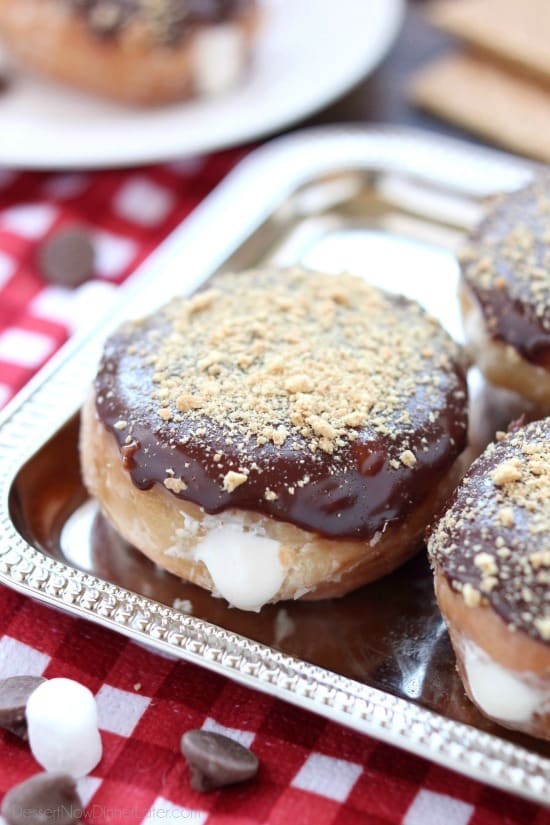 Glazed and ganached, with crushed graham crackers on top, and a marshmallow buttercream center, these S'mores Donuts are delicious and decadent.