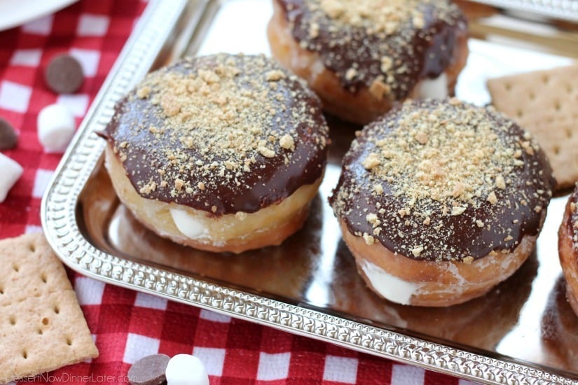 Glazed and ganached, with crushed graham crackers on top, and a marshmallow buttercream center, these S'mores Donuts are delicious and decadent.