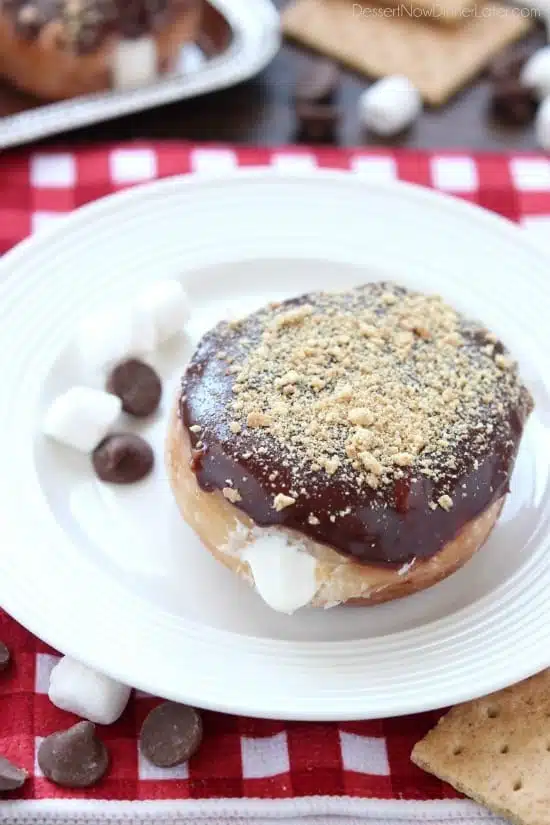 Glazed and ganached, with crushed graham crackers on top, and a marshmallow buttercream center, these S'mores Donuts are delicious and decadent.