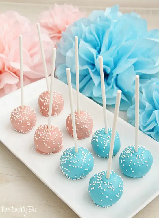 These PINK AND BLUE CAKE POPS are easy to serve at a baby shower and aren't that hard to make. Image from Two Twenty One.