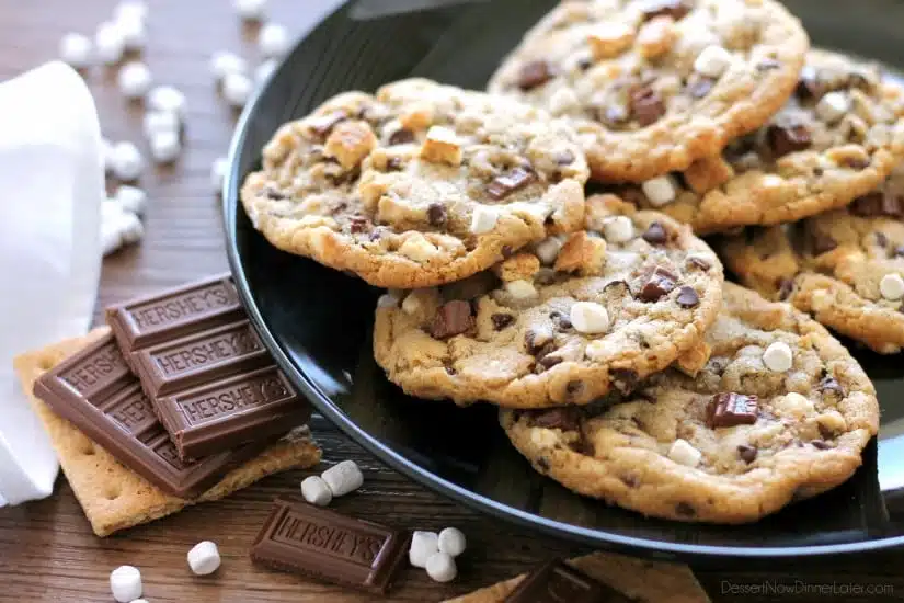 These S'mores Cookies are made with a graham cracker cookie dough, miniature chocolate chips, and marshmallows bits for a great alternative to campfire s'mores that is equally as tasty. 