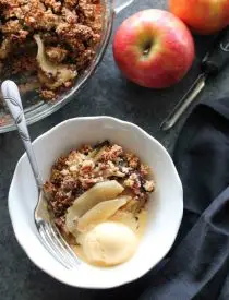 This simple and delicious gluten-free apple crisp is lightly sweet, with a warm hint of cinnamon, and a crunchy nut topping!