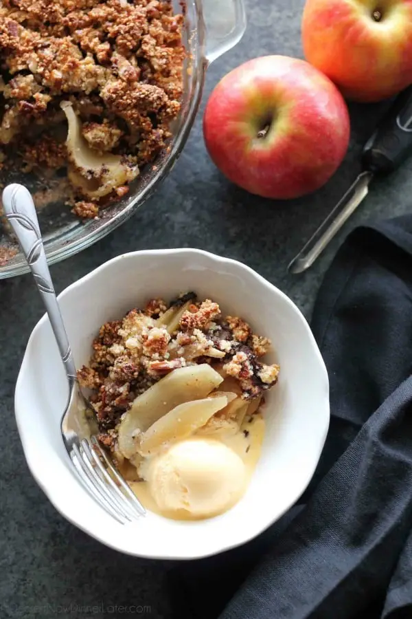 This simple and delicious gluten-free apple crisp is lightly sweet, with a warm hint of cinnamon, and a crunchy nut topping!