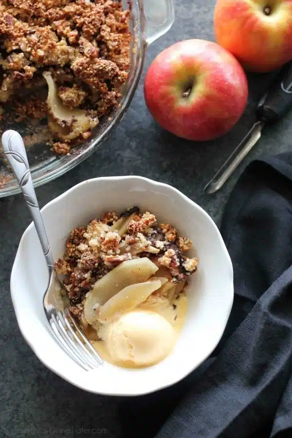 This simple and delicious gluten-free apple crisp is lightly sweet, with a warm hint of cinnamon, and a crunchy nut topping!