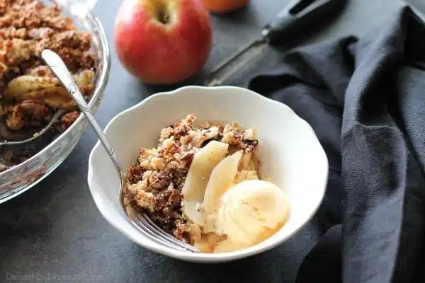 This simple and delicious gluten-free apple crisp is lightly sweet, with a warm hint of cinnamon, and a crunchy nut topping!