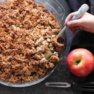 This simple and delicious gluten-free apple crisp is lightly sweet, with a warm hint of cinnamon, and a crunchy nut topping!
