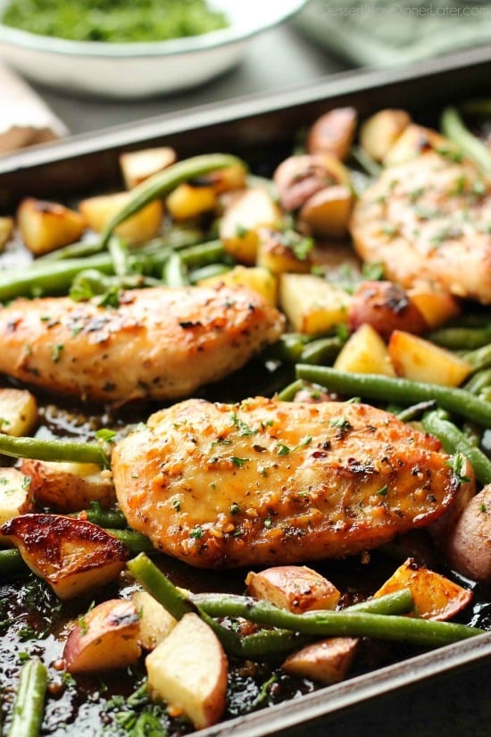 This one pan chicken dinner has the most delicious honey garlic glazed chicken alongside tenderly roasted potatoes and green beans. Plus, it's so easy and flavorful, you'll make again and again!