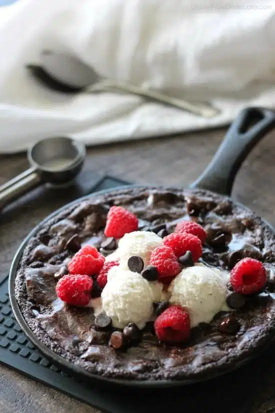 This fudgy skillet brownie is made with a boxed mix for a quick dessert for two! Eat it warm from the oven topped with ice cream, chocolate chips, and fresh raspberries for an extra special treat!