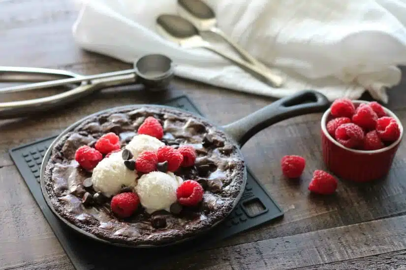 This fudgy skillet brownie is made with a boxed mix for a quick dessert for two! Eat it warm from the oven topped with ice cream, chocolate chips, and fresh raspberries for an extra special treat!