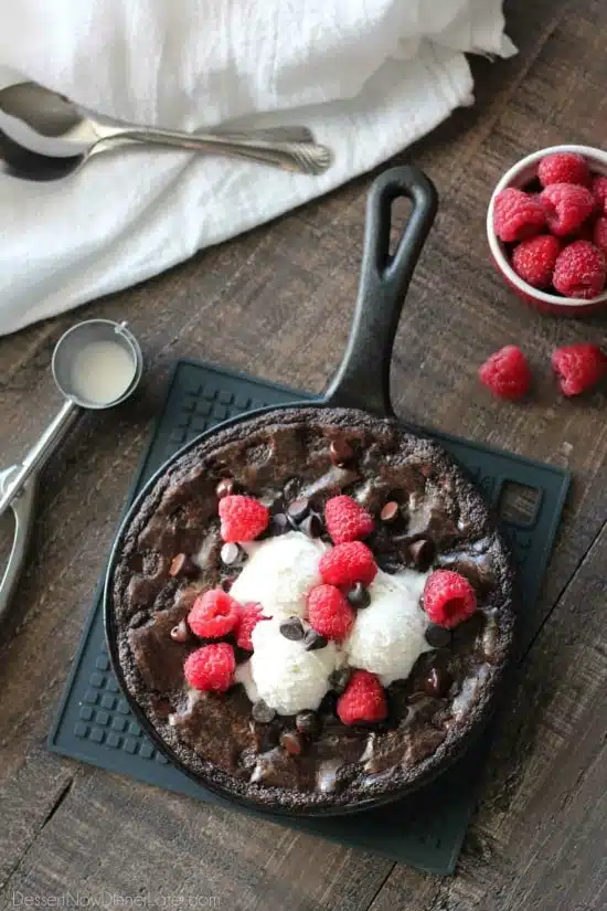 This fudgy skillet brownie is made with a boxed mix for a quick dessert for two! Eat it warm from the oven topped with ice cream, chocolate chips, and fresh raspberries for an extra special treat!