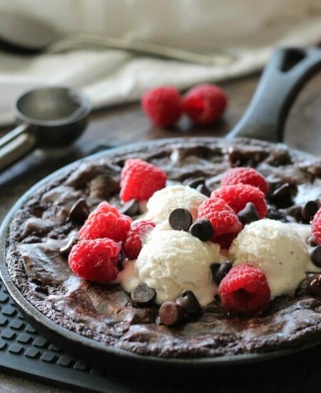 This fudgy skillet brownie is made with a boxed mix for a quick dessert for two! Eat it warm from the oven topped with ice cream, chocolate chips, and fresh raspberries for an extra special treat!