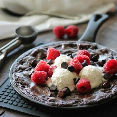 This fudgy skillet brownie is made with a boxed mix for a quick dessert for two! Eat it warm from the oven topped with ice cream, chocolate chips, and fresh raspberries for an extra special treat!