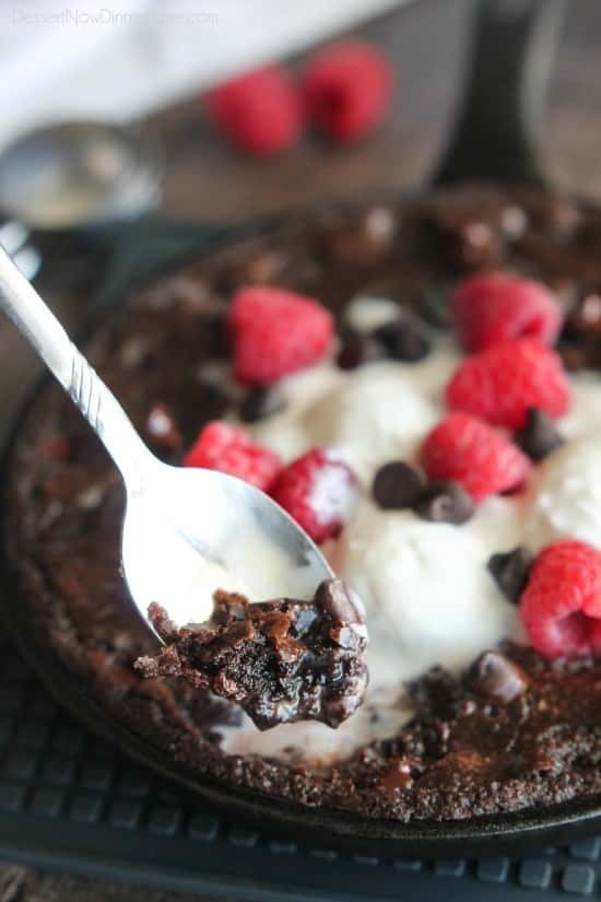 This fudgy skillet brownie is made with a boxed mix for a quick dessert for two! Eat it warm from the oven topped with ice cream, chocolate chips, and fresh raspberries for an extra special treat!