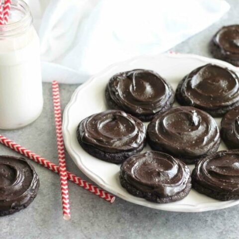 Fudgy dark chocolate sugar cookies are frosted with a creamy chocolate buttercream frosting. Inspired by Swig's Dirtball Cookie, these frosted chocolate sugar cookies are sure to be a new favorite!
