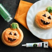 Orange Pumpkin Rolls - Pumpkin shaped orange rolls are decorated to look like jack-o-lanterns for Halloween.