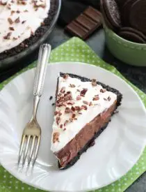 Homemade chocolate pudding topped with sweetened whipped cream, all nestled inside a chocolate cookie crust, makes the most delicious no-bake Chocolate Pudding Pie.