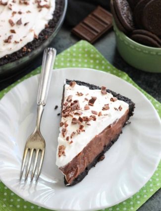 Homemade chocolate pudding topped with sweetened whipped cream, all nestled inside a chocolate cookie crust, makes the most delicious no-bake Chocolate Pudding Pie.
