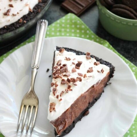 Homemade chocolate pudding topped with sweetened whipped cream, all nestled inside a chocolate cookie crust, makes the most delicious no-bake Chocolate Pudding Pie.