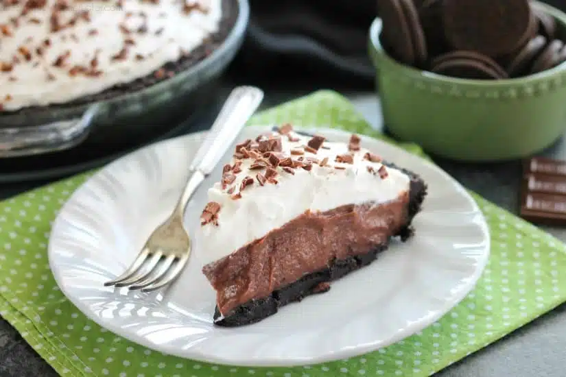 Homemade chocolate pudding topped with sweetened whipped cream, all nestled inside a chocolate cookie crust, makes the most delicious no-bake Chocolate Pudding Pie.