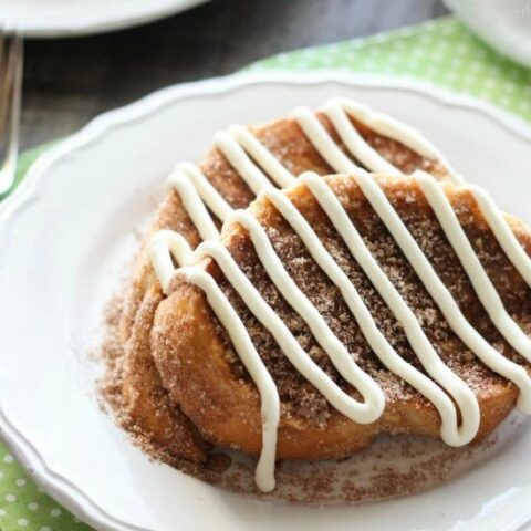 Churro French Toast - Thick slices of French bread are battered and pan fried, then dipped in cinnamon-sugar, and topped with a buttery cream cheese frosting. Delicious!