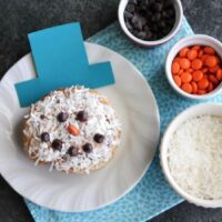 This Cinnamon Roll Snowman is a fun holiday food craft for kids and only takes two minutes to make!