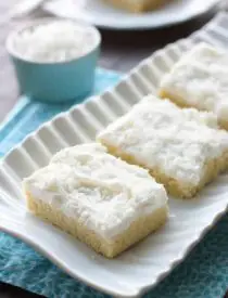 These Coconut Sugar Cookie Bars have lots of delicious coconut flavor from the crust, to the frosting, and the shredded coconut on top. Plus, they are super soft, chewy, and easy to make!