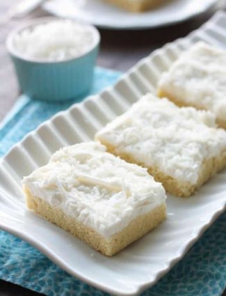 These Coconut Sugar Cookie Bars have lots of delicious coconut flavor from the crust, to the frosting, and the shredded coconut on top. Plus, they are super soft, chewy, and easy to make!