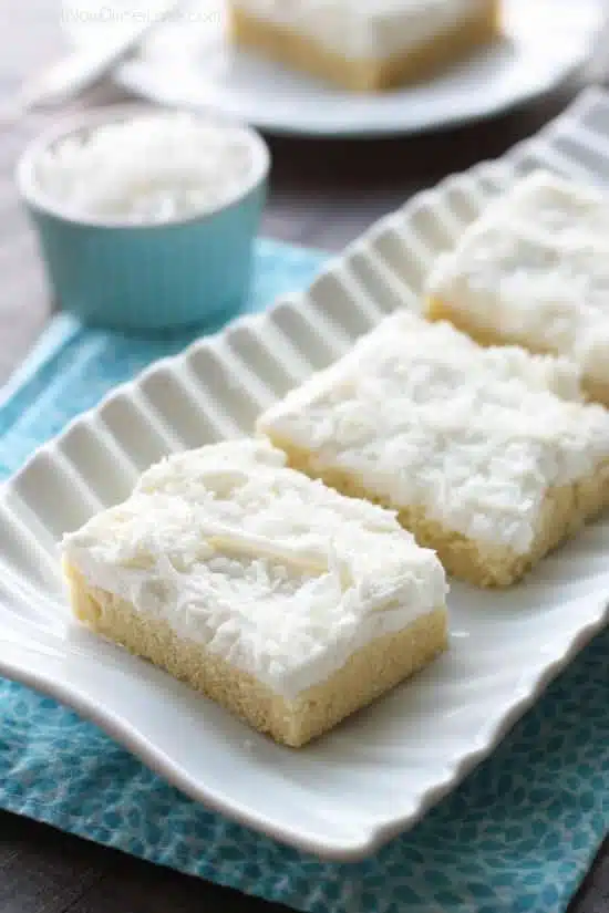 These Coconut Sugar Cookie Bars have lots of delicious coconut flavor from the crust, to the frosting, and the shredded coconut on top. Plus, they are super soft, chewy, and easy to make!