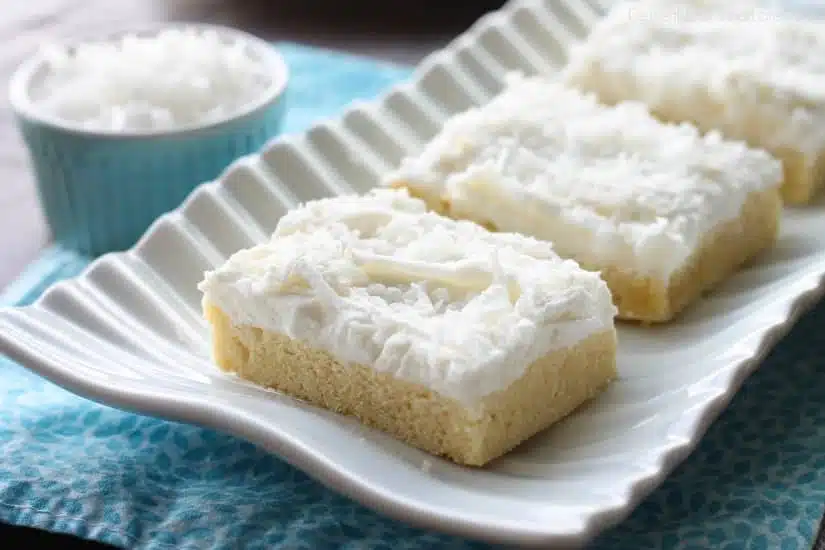 These Coconut Sugar Cookie Bars have lots of delicious coconut flavor from the crust, to the frosting, and the shredded coconut on top. Plus, they are super soft, chewy, and easy to make!