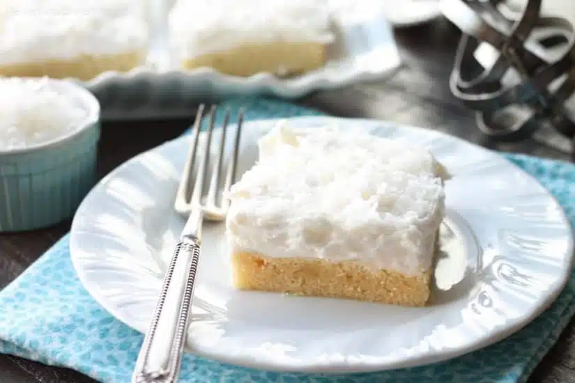 These Coconut Sugar Cookie Bars have lots of delicious coconut flavor from the crust, to the frosting, and the shredded coconut on top. Plus, they are super soft, chewy, and easy to make!