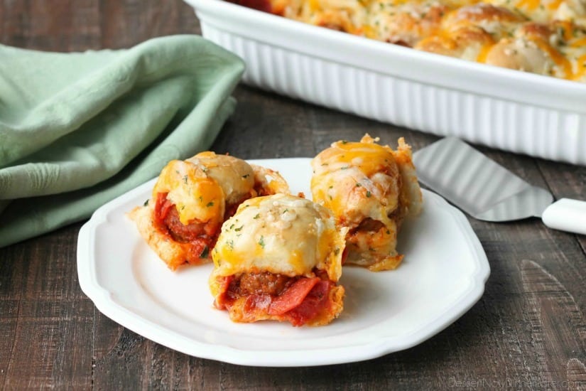 This deep dish casserole is a meatball sandwich and pizza in one! Saucy meatballs and pieces of pepperoni are sandwiched between fresh bread and topped with cheese for a hearty dinner, party appetizer, or sports game snack.