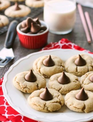 Peanut Butter Blossoms, Peanut Butter Kiss Cookies, and Peanut Butter Thumbprints are all one and the same. An easy and delicious soft peanut butter cookie with a large chocolate morsel center. Makes a great Christmas cookie to share with family and friends!