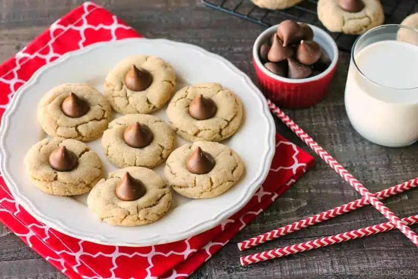 Peanut Butter Blossoms, Peanut Butter Kiss Cookies, and Peanut Butter Thumbprints are all one and the same. An easy and delicious soft peanut butter cookie with a large chocolate morsel center. Makes a great Christmas cookie to share with family and friends!