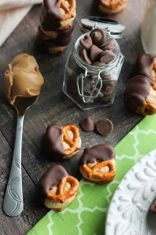 Peanut Butter Balls are made into pretzel bites for a salty-sweet addicting treat! Perfect for parties or Christmas neighbor gifts!