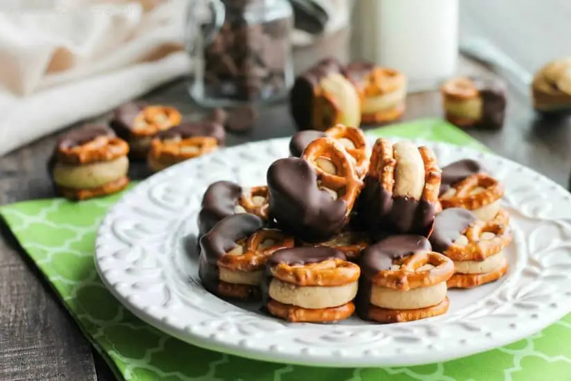 Peanut Butter Balls are made into pretzel bites for a salty-sweet addicting treat! Perfect for parties or Christmas neighbor gifts!