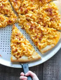 Mac and Cheese Pizza combines two tasty dinners into one incredible meal. It's so easy, the kids can make it! Top it with bacon for extra deliciousness!