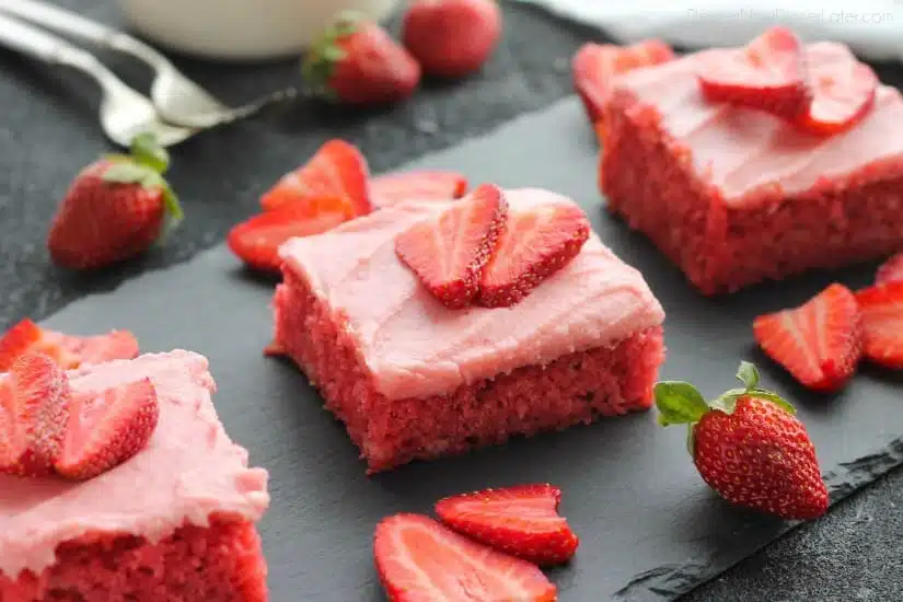 This strawberry cake uses fresh strawberries and flavored gelatin for a super flavorful strawberry sheet cake that will feed a crowd. It's really easy, and incredibly moist too!