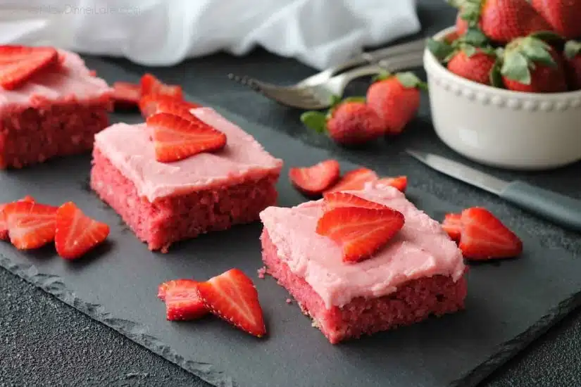 This strawberry cake uses fresh strawberries and flavored gelatin for a super flavorful strawberry sheet cake that will feed a crowd. It's really easy, and incredibly moist too!